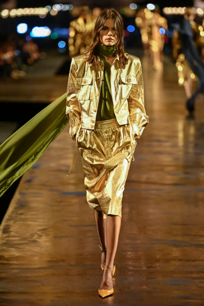 Model wearing a gold Saint Laurent Spring 2027 runway look during Paris Fashion Week.